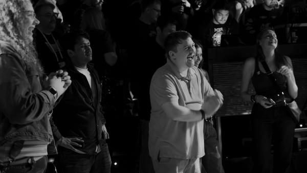 Crowd clapping and smiling joyfully